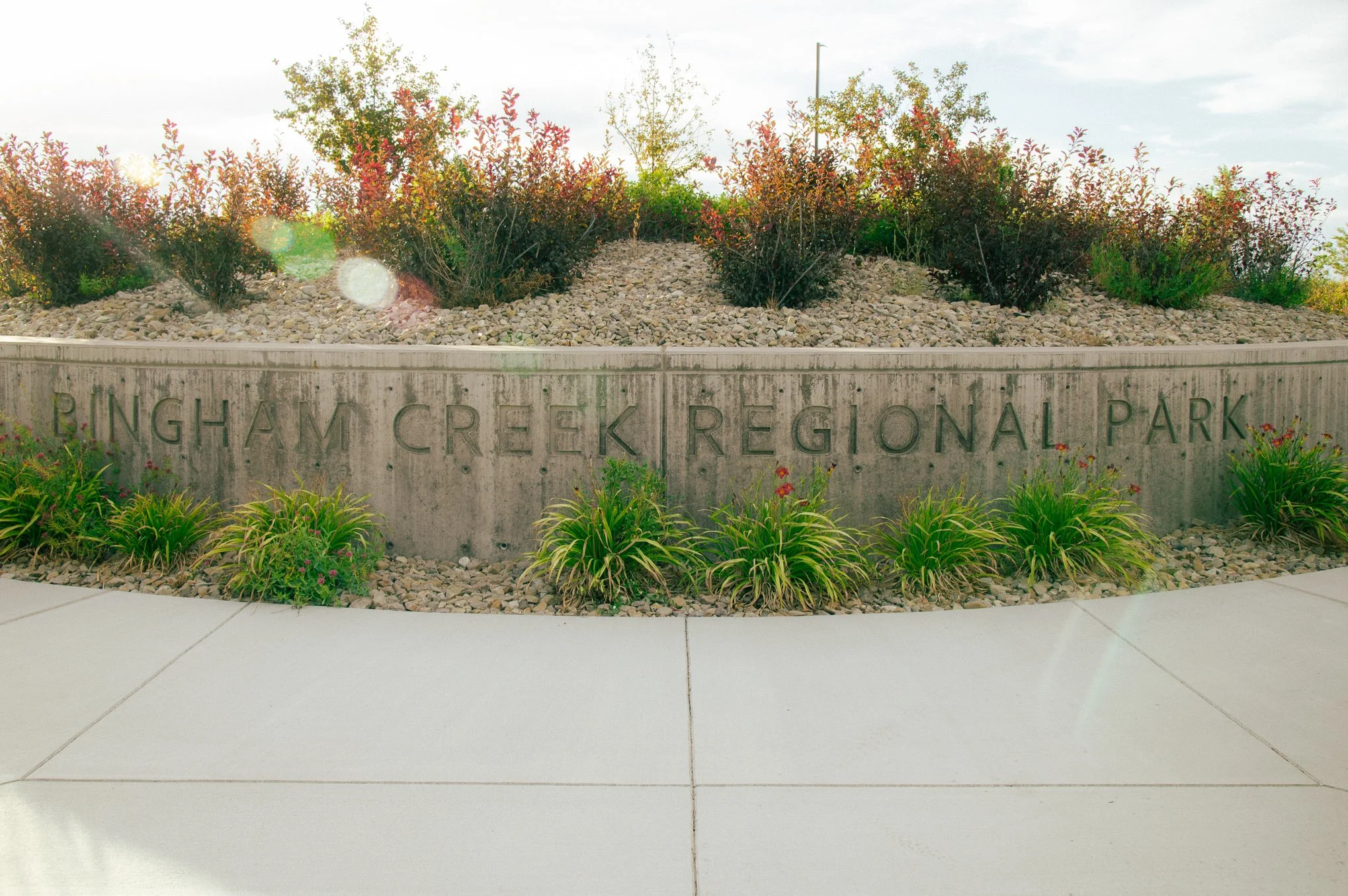 Bingham Creek Regional Park entrance sign surrounded by landscaping in South Jordan, Utah, a family portrait location serving families in the Greater Salt Lake Valley.