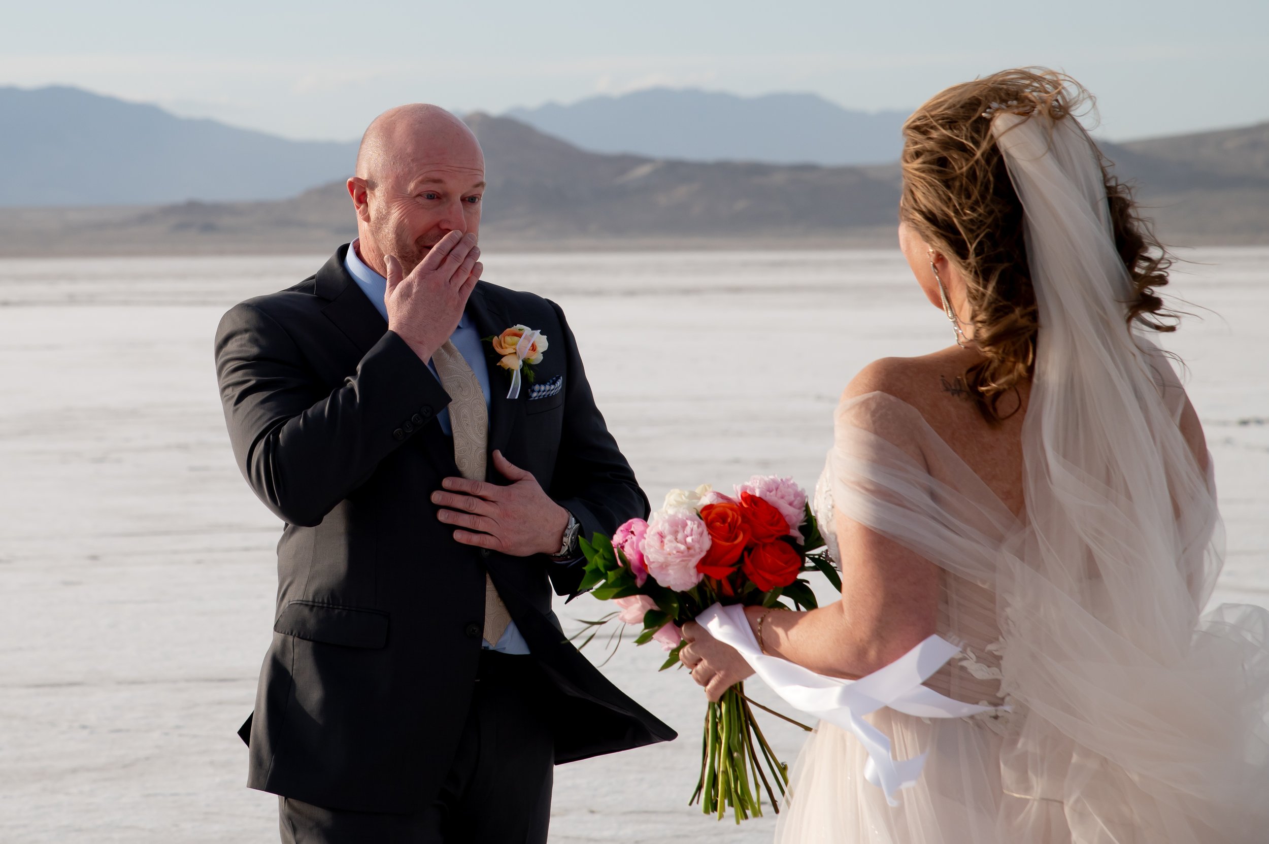 Groom reacts emotionally seeing his bride for the first time at the Utah Salt Flats.
