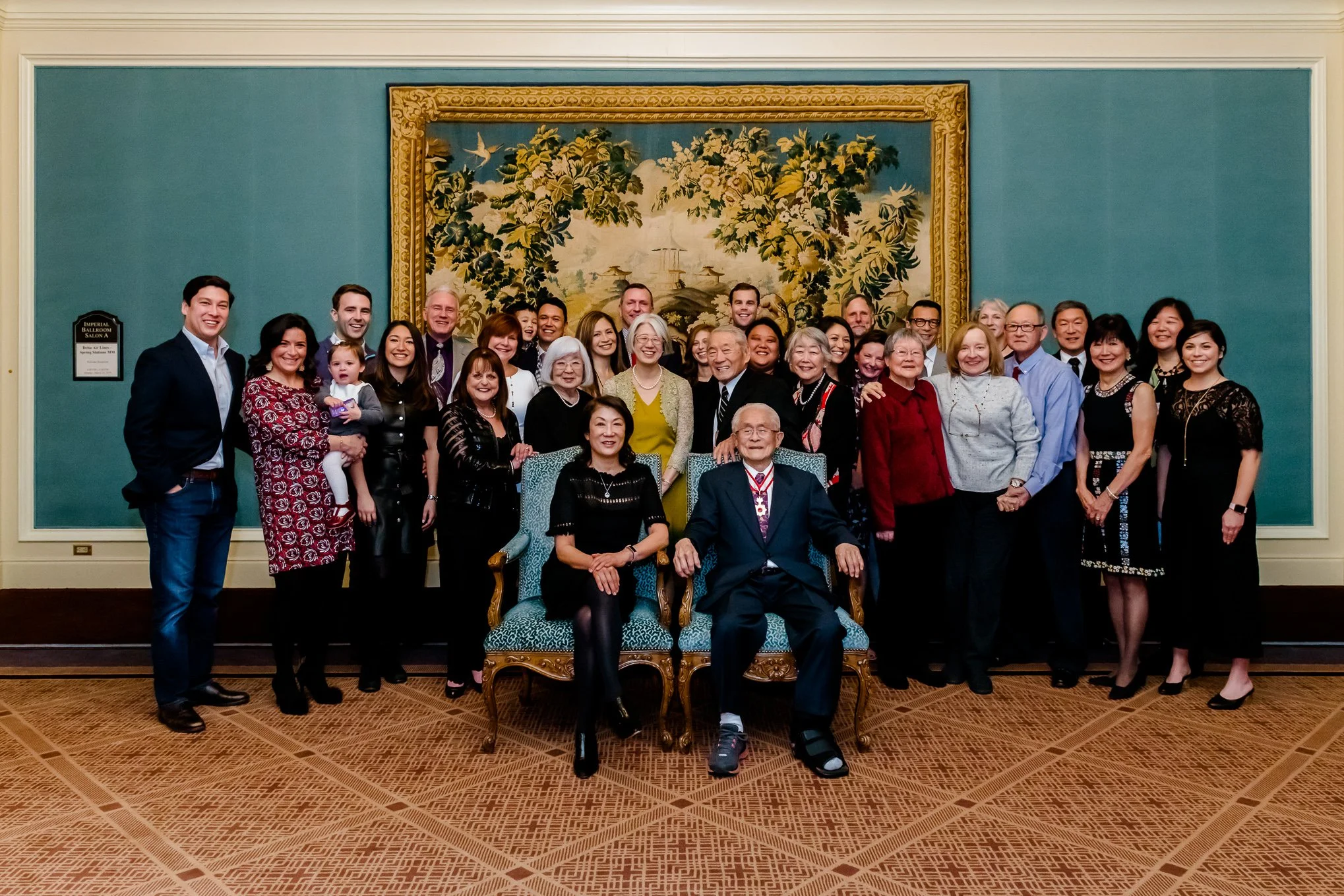 Extended Family Portrait in front of a tapestry at Grand America Hotel