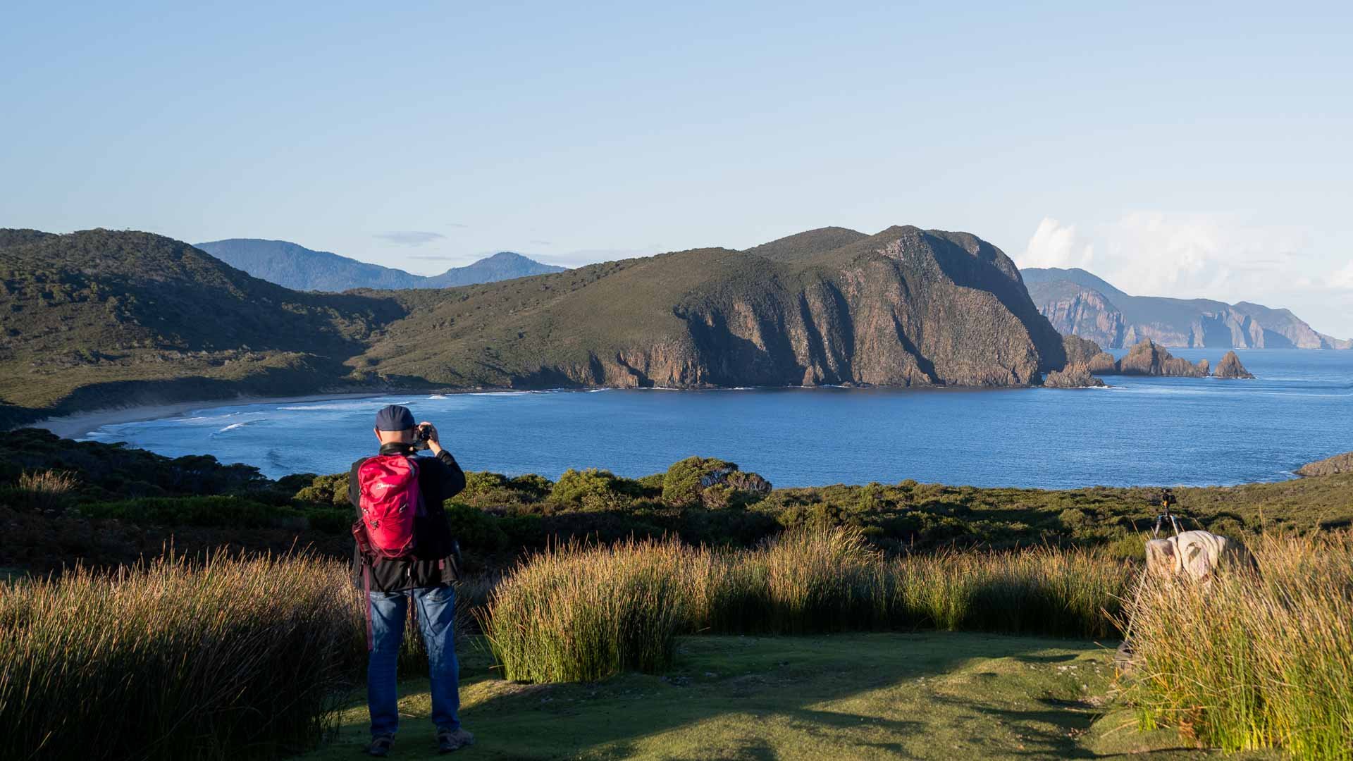 A person photographing the coastline of Bruny Island, Tasmania