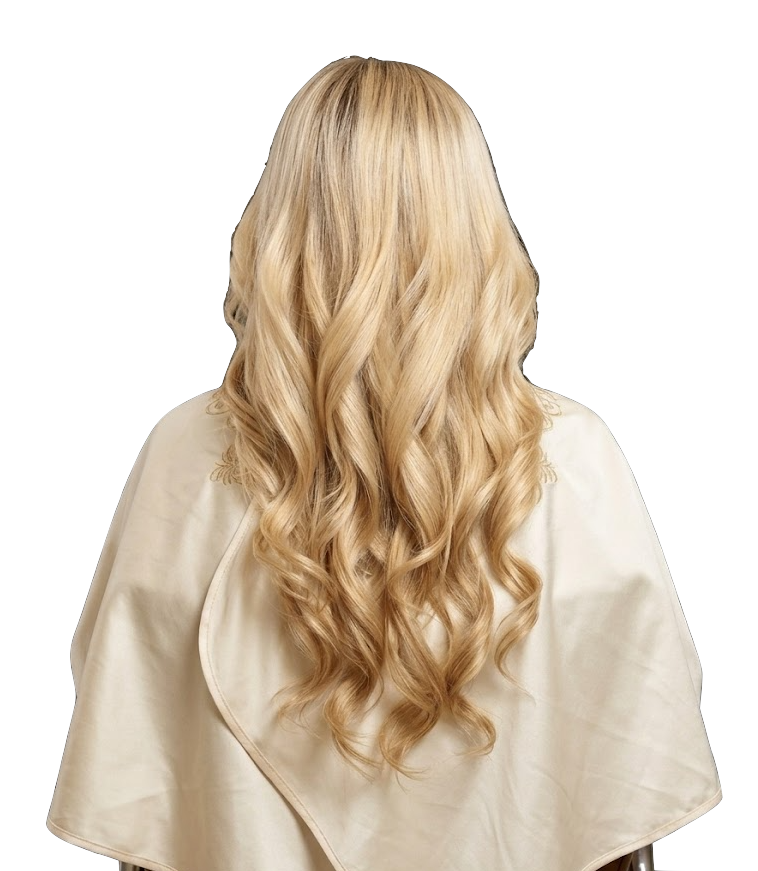 Woman with long, blonde, wavy hair wearing a salon cape, viewed from the back.