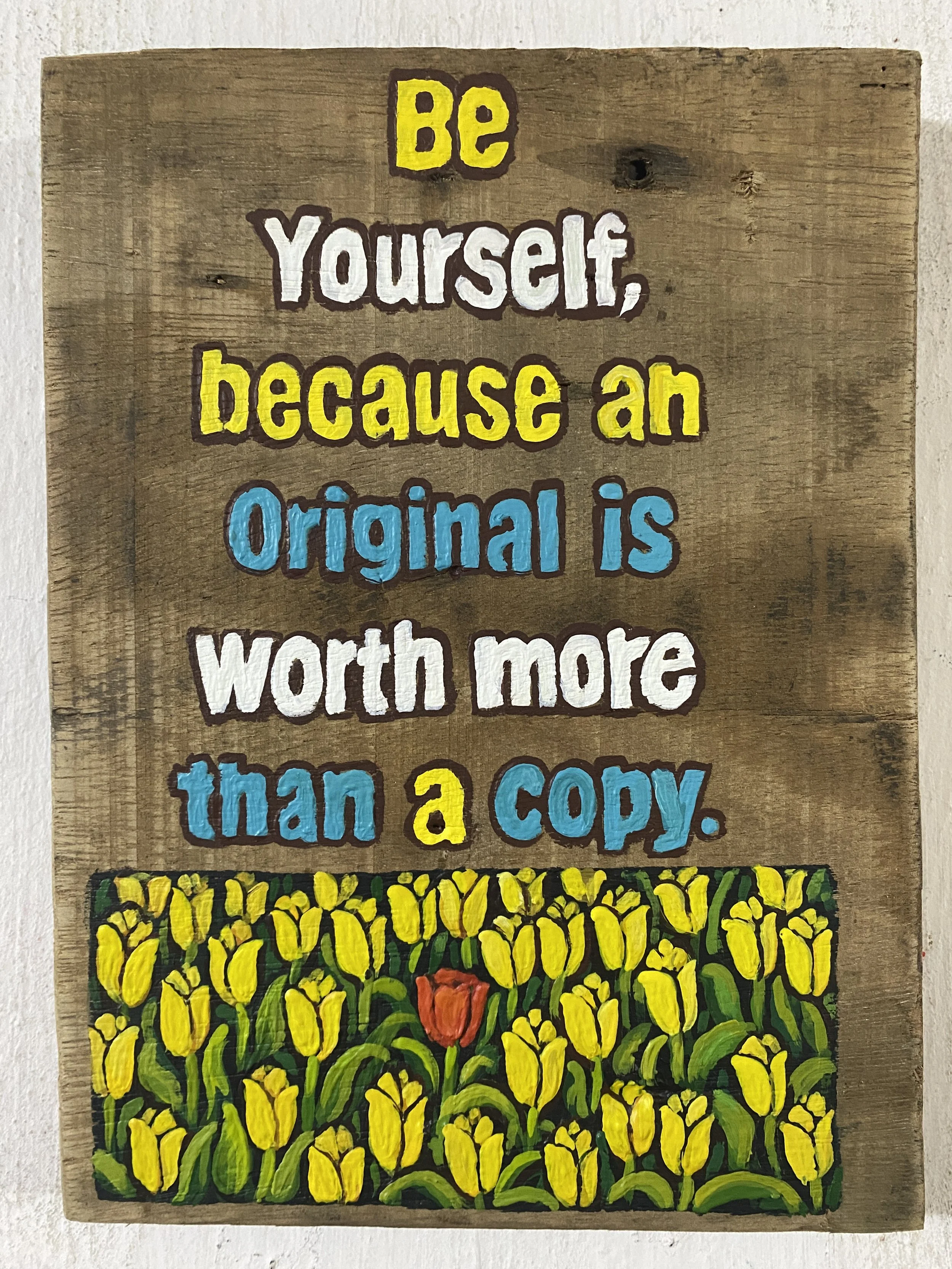 Colorful hand-painted wooden sign with a motivational quote and a background illustration of yellow tulips and a single red flower.