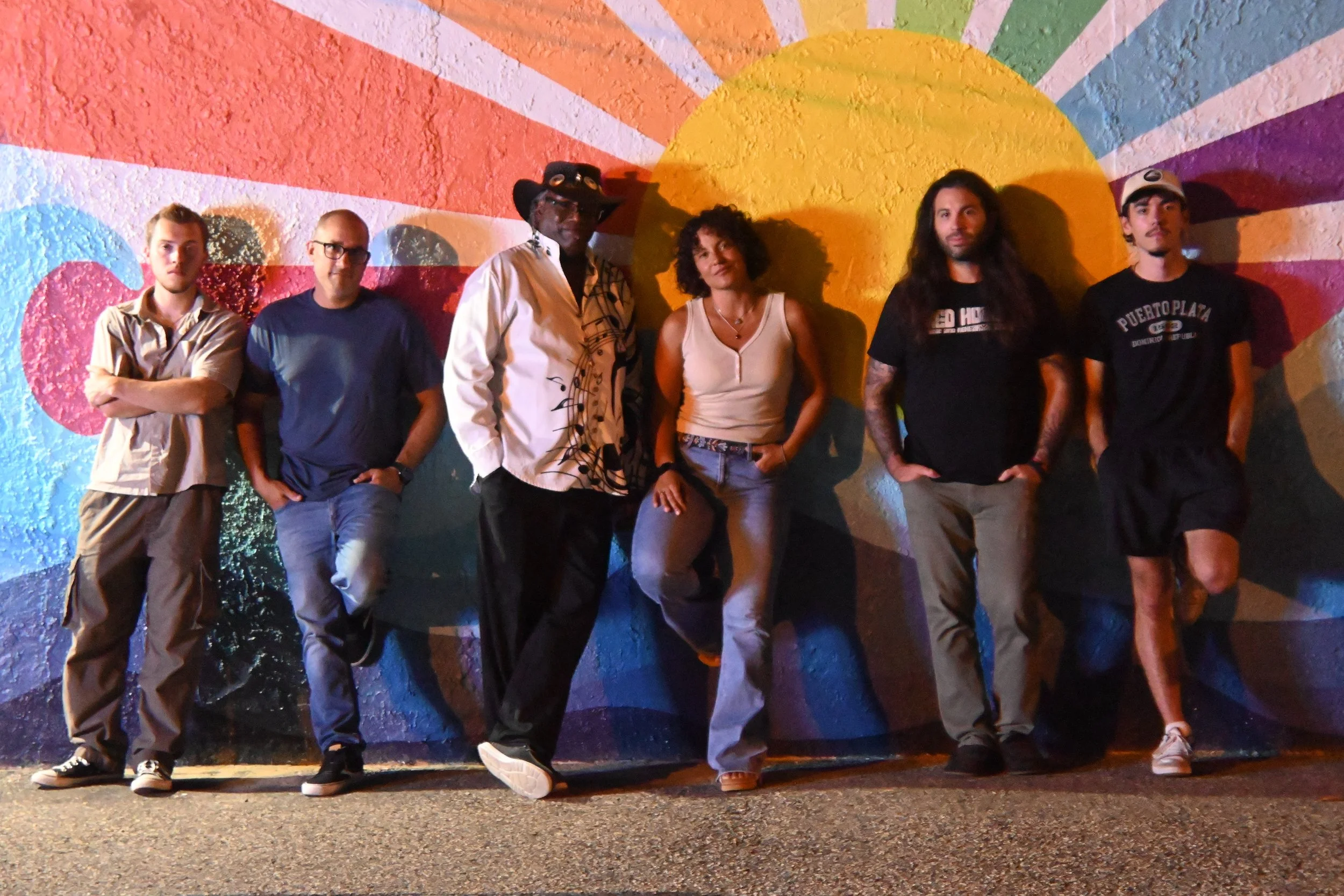 The Red House Band, based in Point Pleasant, NJ, pose in front of a local mural.