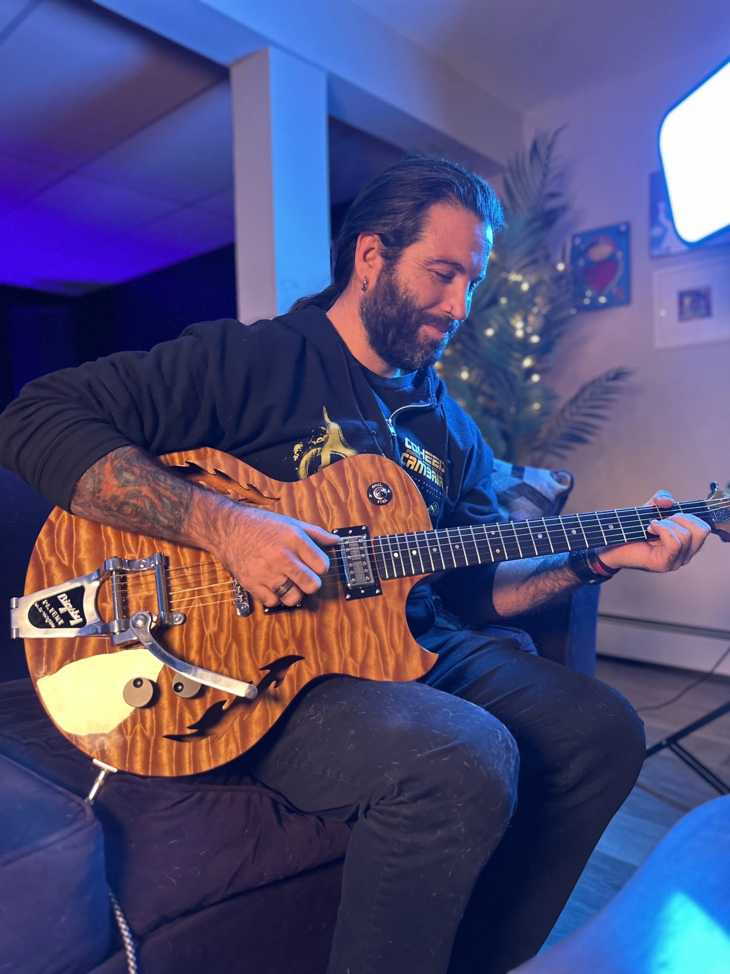 Red House Music and Rehearsal Studio founder and instructor, Erik Reynolds, holds a Soulfire electric guitar. Erik teaches acoustic and electric guitar, drums, bass, and piano in Point Pleasant, NJ. 
