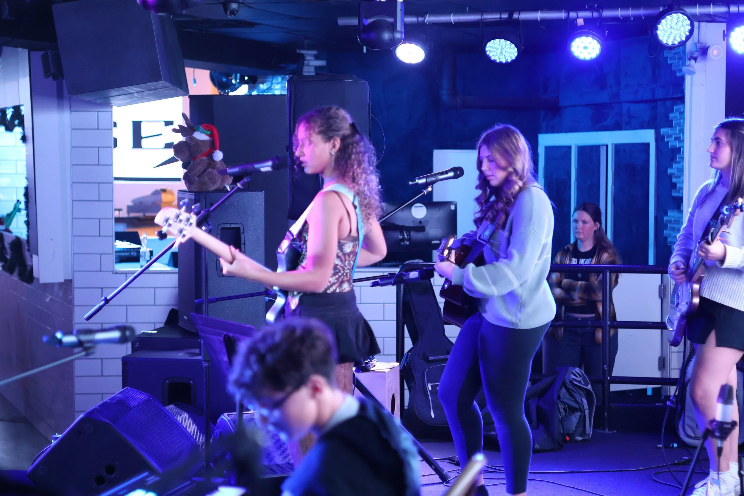 Red House Music and Rehearsal Studio performance band students performing live music on stage at Headliner Nightclub in Neptune, NJ.