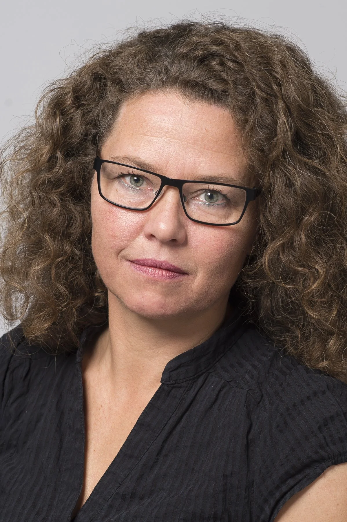 Photo of Aud Tennøy with black top and glasses.