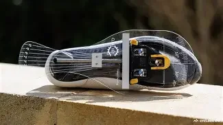 Close-up of a black and gray snowboard binding mounted on a snowboard.