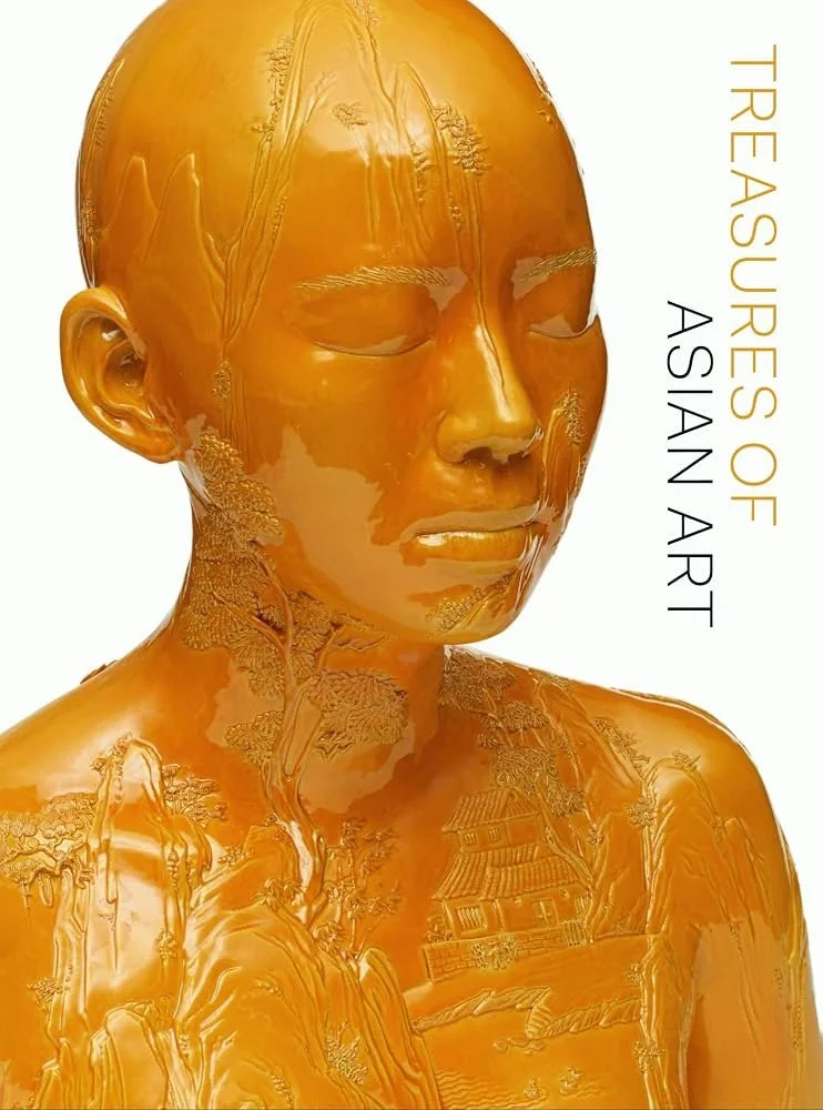 A golden sculpture of a woman's face and upper body with detailed patterns of trees and buildings carved into it. Text on the right reads 'Tree Ares of A. Saran Art'.