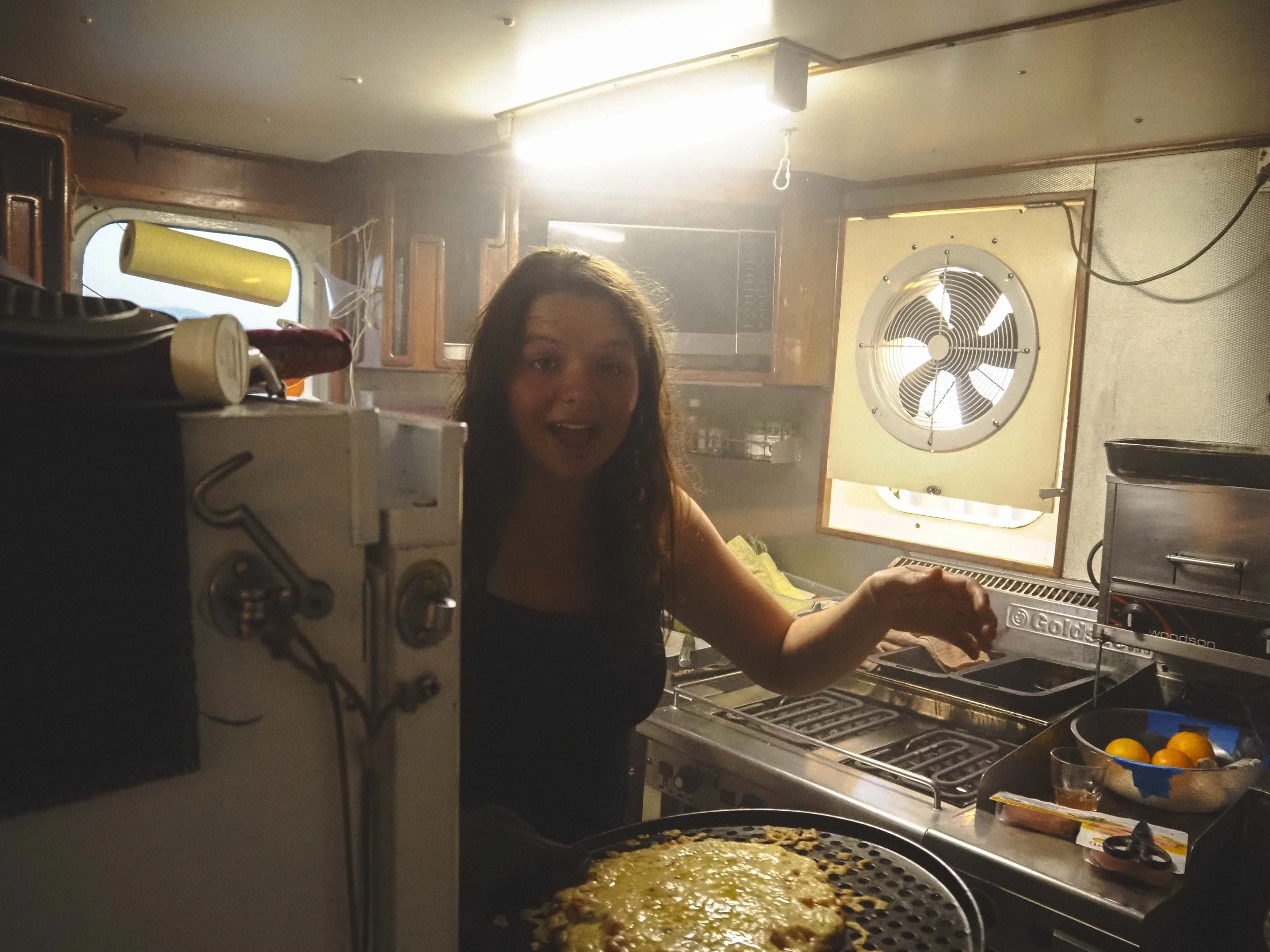  The small galley transforms into a commercial kitchen for pizza night on board. 