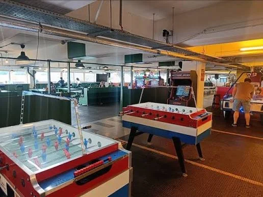 A photo showing foosball tables and an arcade machine in Peckham Levels