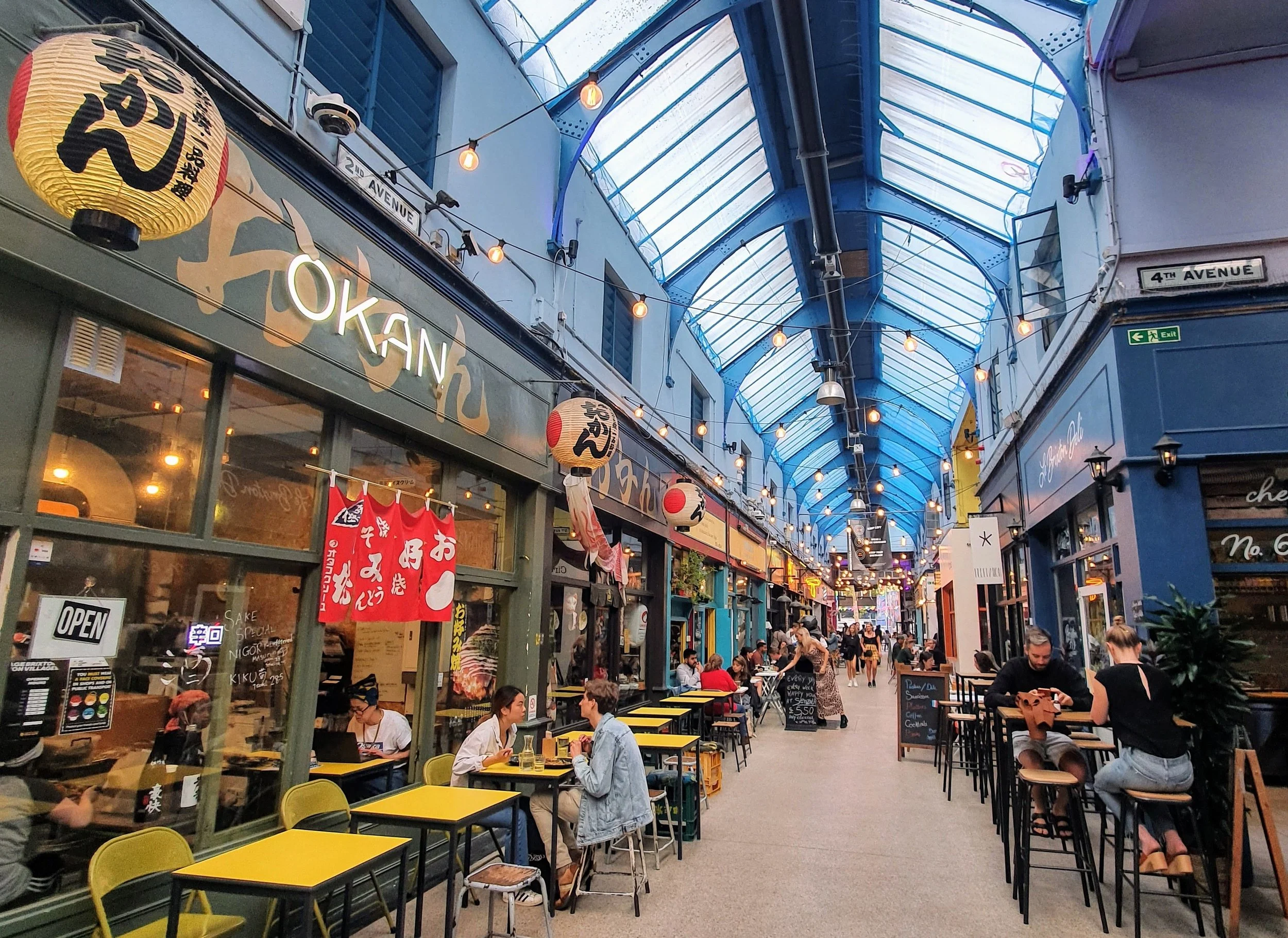 A photo showing the inside of Brixton Village featuring "Okan" restaurant