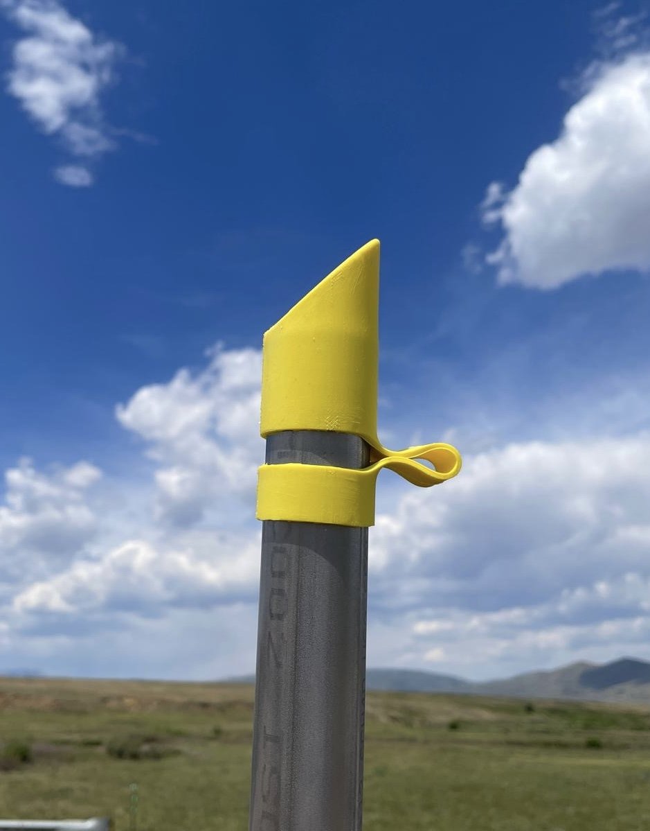A Yellow WWC Wyoming Weathercap Protecting acting as a rain jacket, visual indicator, and enabling a reduction in fugitive emmissions