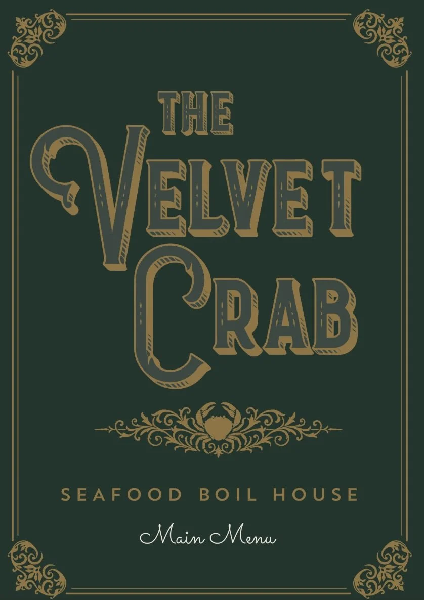 Menu cover for The Velvet Crab Seafood Boil House with decorative gold flourish designs in each corner, including a crab in a symmetrical design below the text, set against a dark green background.