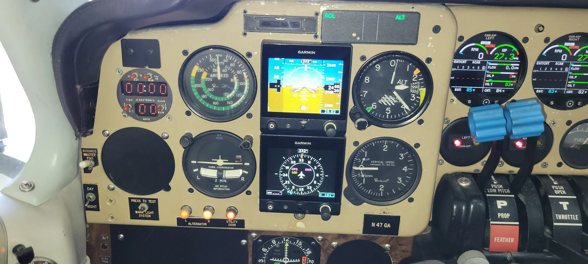 Aircraft cockpit instrumentation panel with various gauges, screens, and controls.