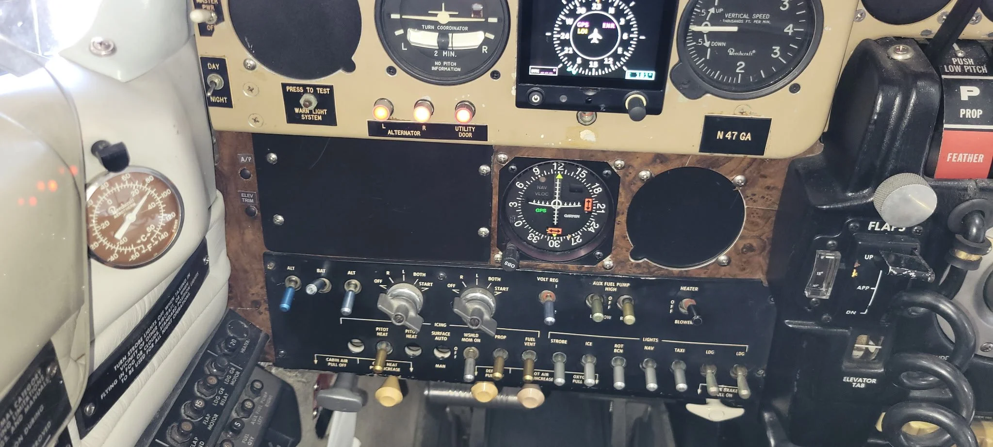 Close-up of an aircraft cockpit panel with various gauges, switches, and controls, including altimeter, heading indicator, fuel gauges, and communication equipment.