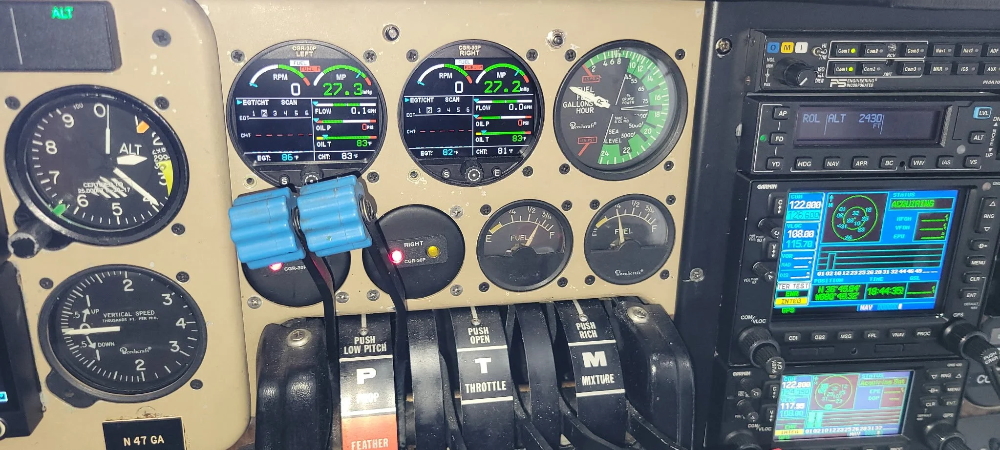 Aircraft cockpit instrument panel with various gauges and electronic displays