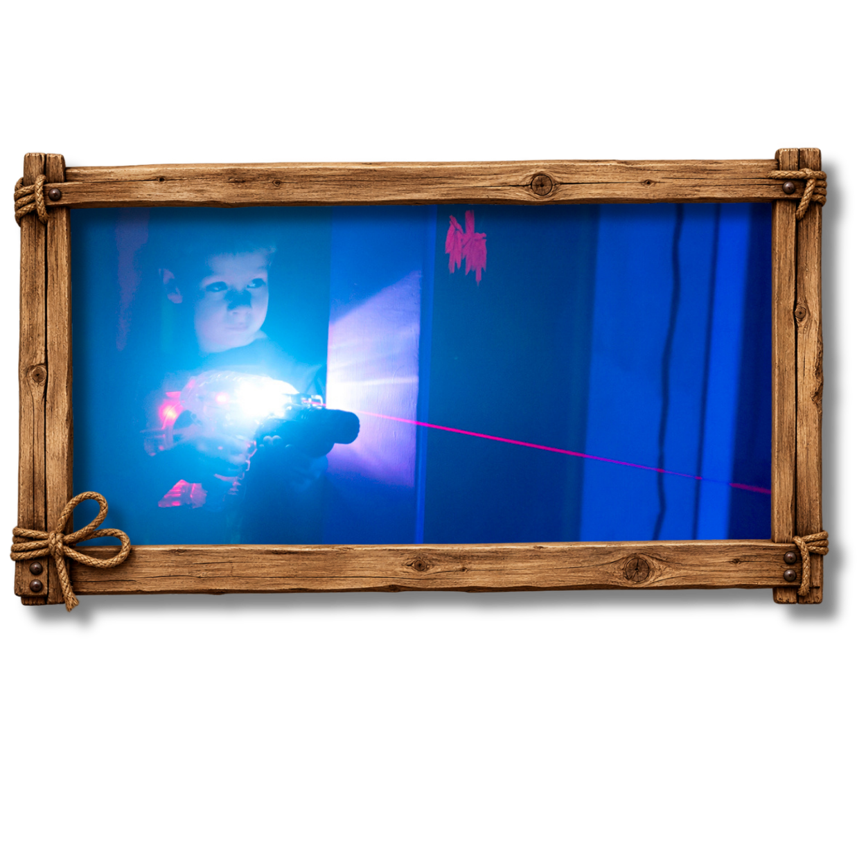 A young boy aiming a laser gun at a target with a blue light, in a dark room with blue curtains behind him.