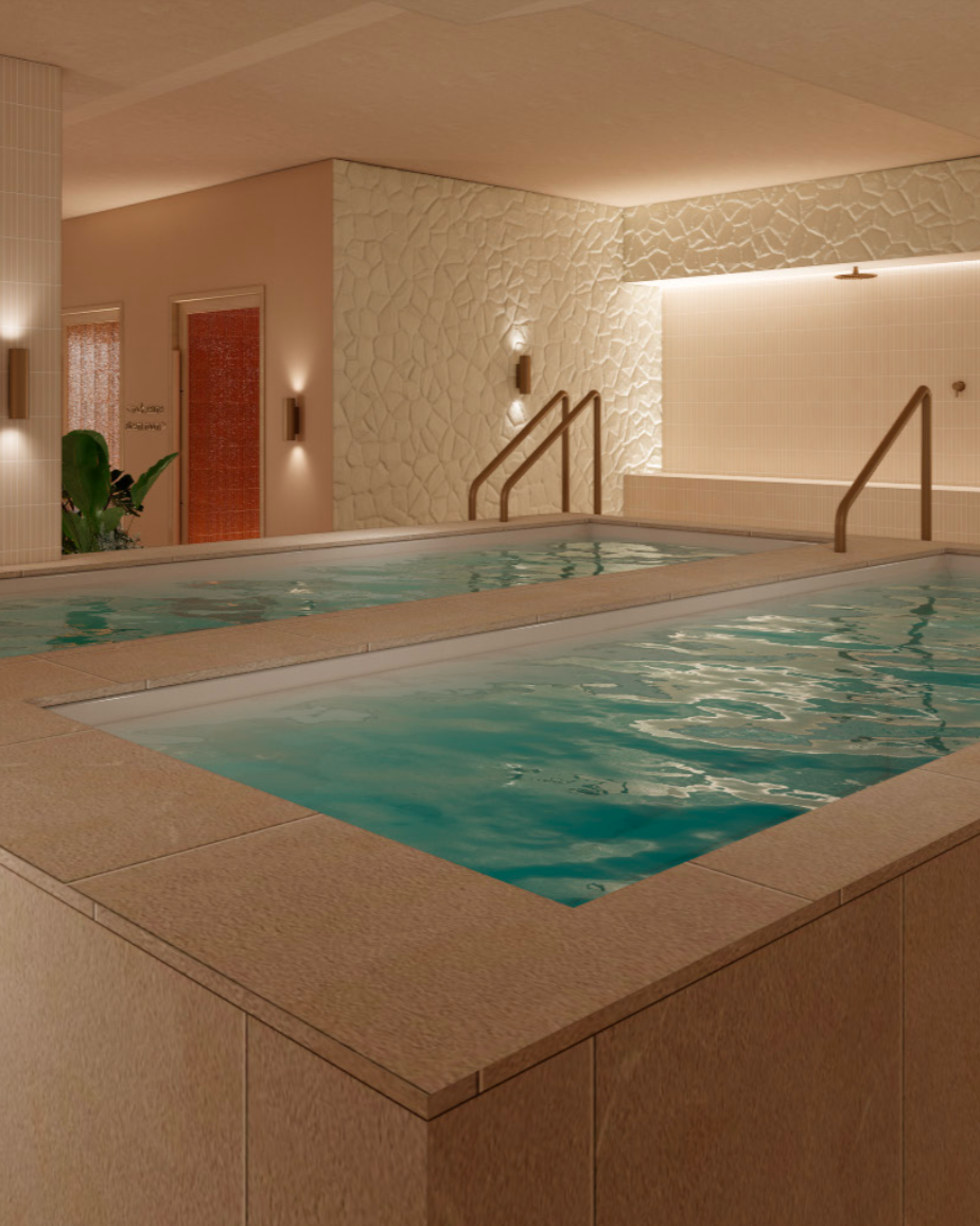 Indoor hot tubs with water, surrounded by tiled walls and steps, in a spa or wellness center.