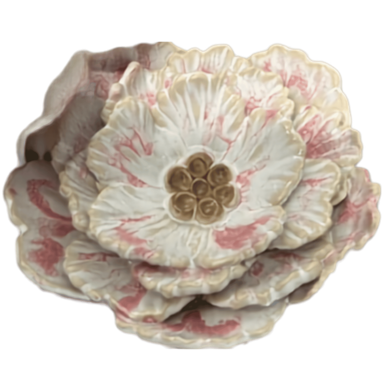 Close-up of a decorative flower sculpture with layered, textured petals in white and pink hues and a cluster of brown seed-like structures at the center.