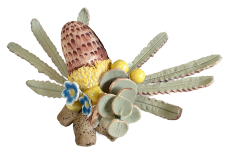 Decorative sculpture resembling a flower with a cone-shaped top, yellow interior, blue and yellow small rounded elements, and elongated green and pink leaves or petals.