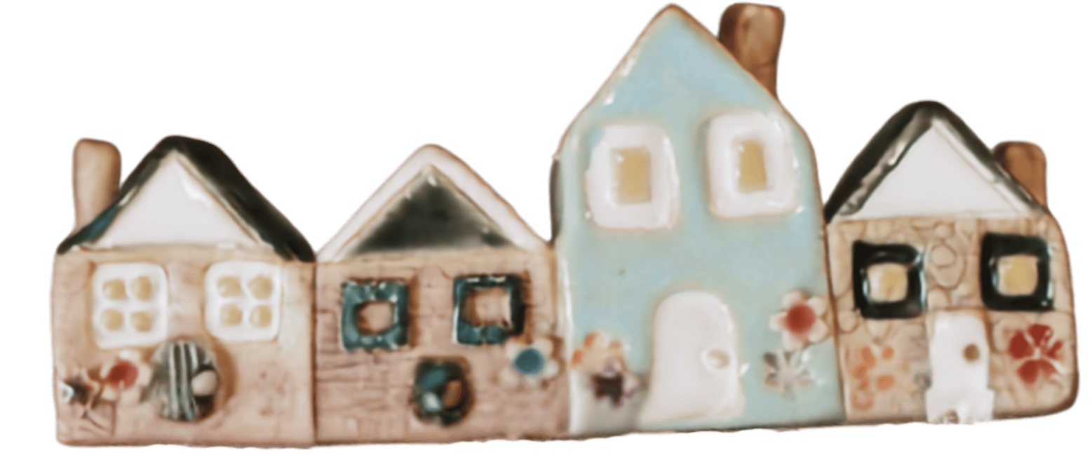 Colorful ceramic or porcelain houses with decorated windows and doors, arranged in a row.
