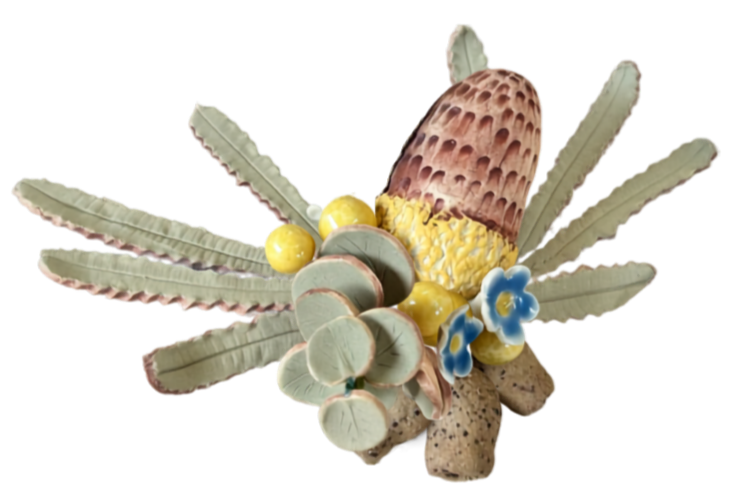 Decorative arrangement resembling an animal, with an egg-shaped object, flowers, and various textured elements.