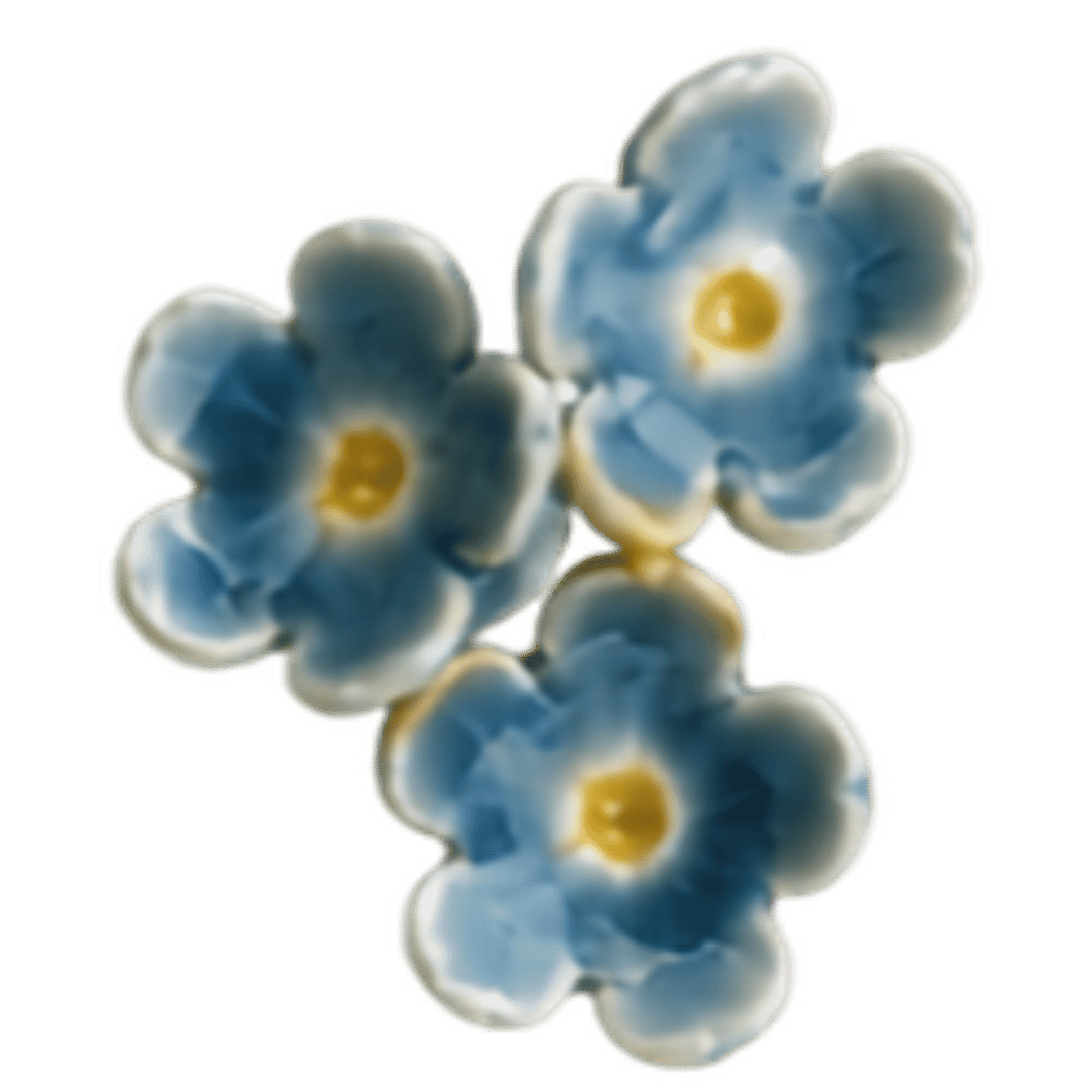 Three small white flowers with yellow centers on green stems against a black background.