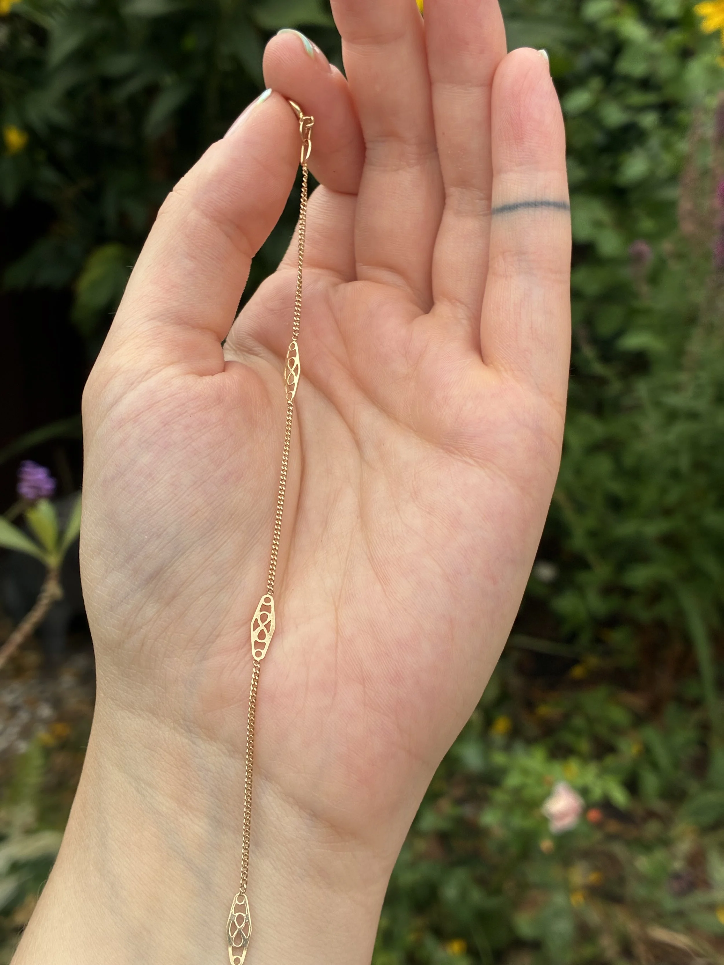 Fancy Link Bracelet held in hand