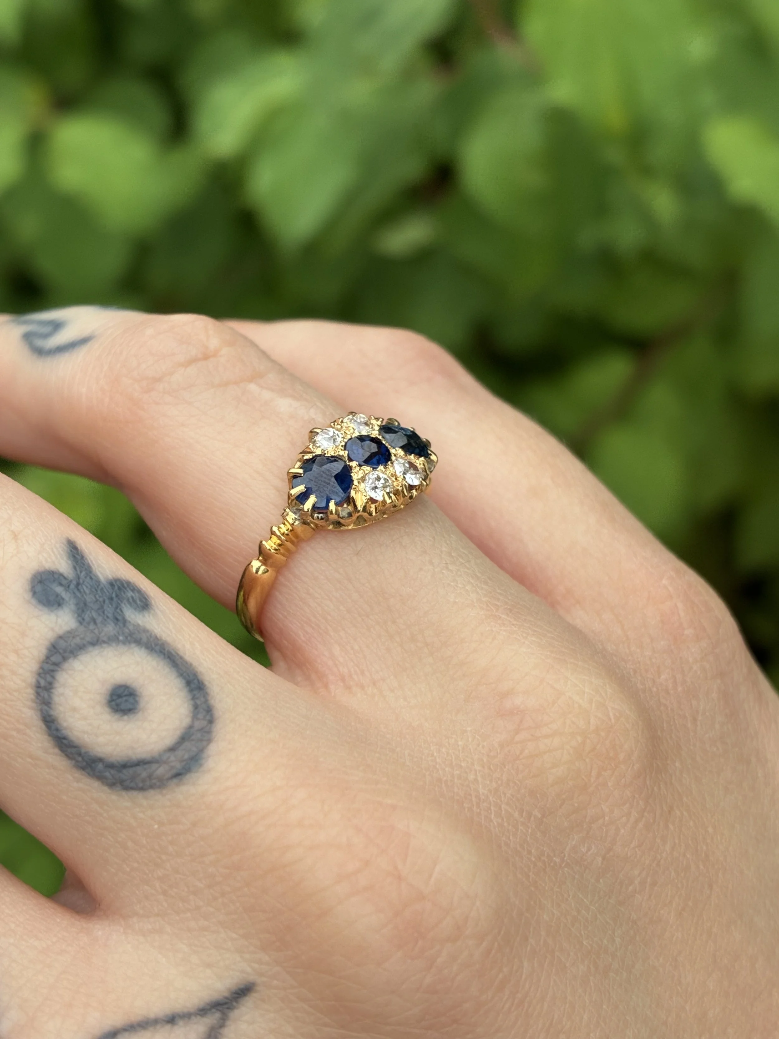 Beautiful Sapphire and Diamond cluster ring on hand