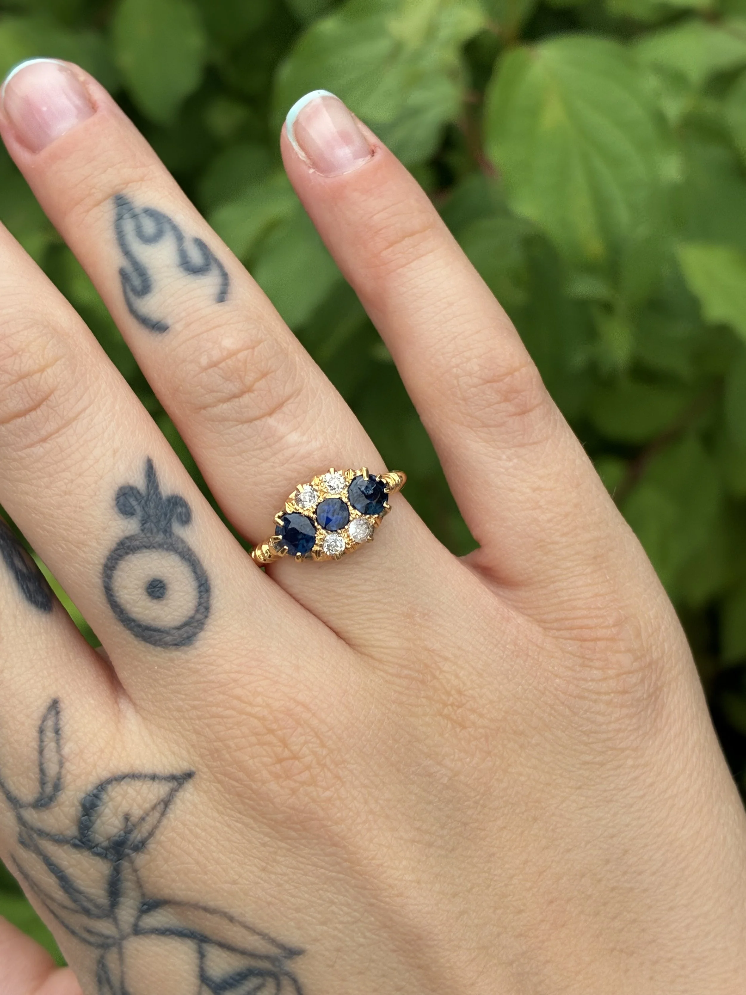 Beautiful Sapphire and Diamond cluster ring on hand