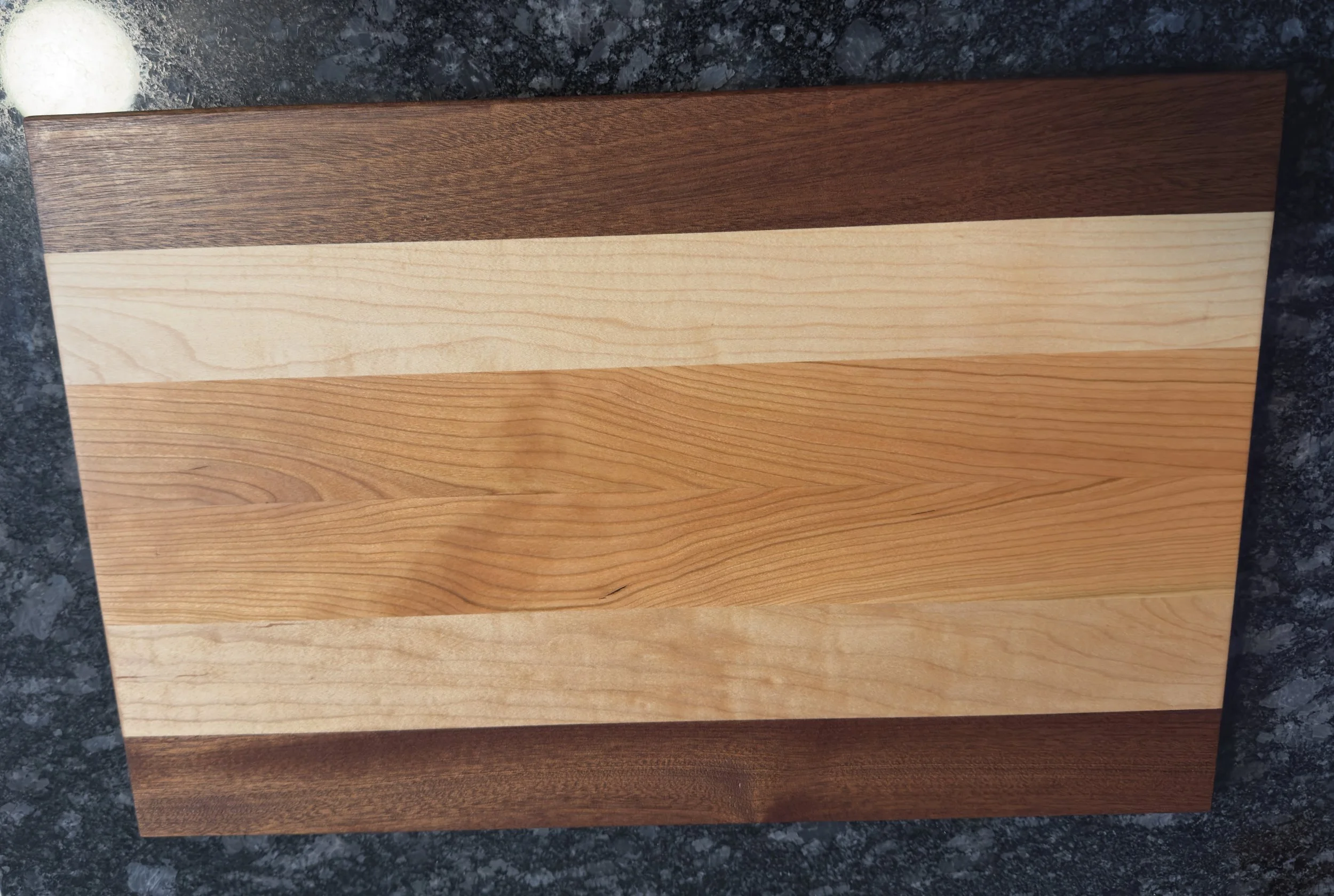 Lightweight striped wooden cutting board without handles