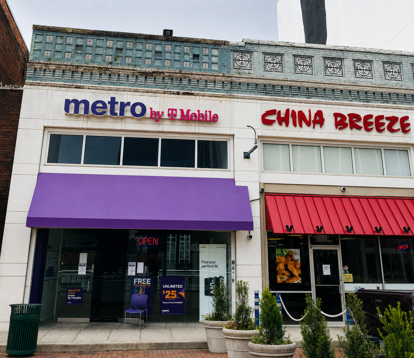 Storefront with signs for Metro by T Mobile and China Breeze, a purple awning, and red awning, with plants and a sidewalk in front.