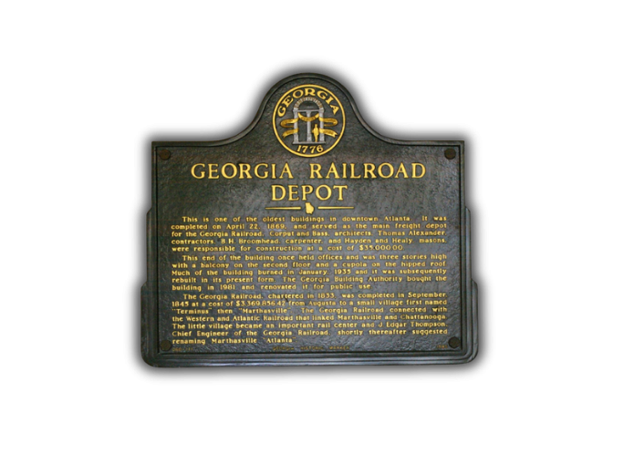 Historical plaque for Georgia Railroad Depot in Atlanta with yellow text on a dark background.
