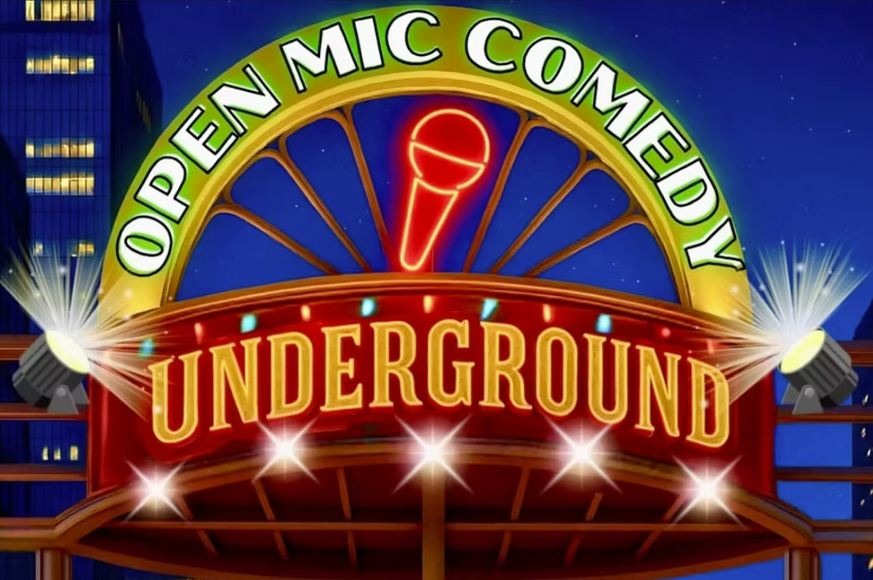 Sign for the Open Mic Comedy Underground with bright lights and a neon microphone symbol at night.