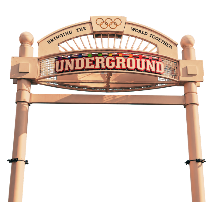 Entrance sign for an underground transit station with the words 'Bringing the World Together' and the Olympic rings logo.