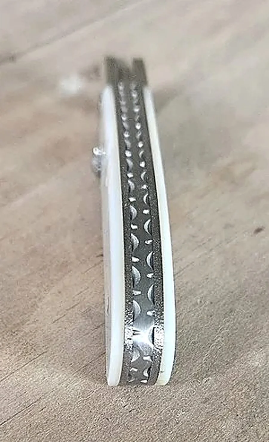 B.A. Dodson mother-of-pearl and Mokume folding knife spine detail showing the decorative filework and handle construction.