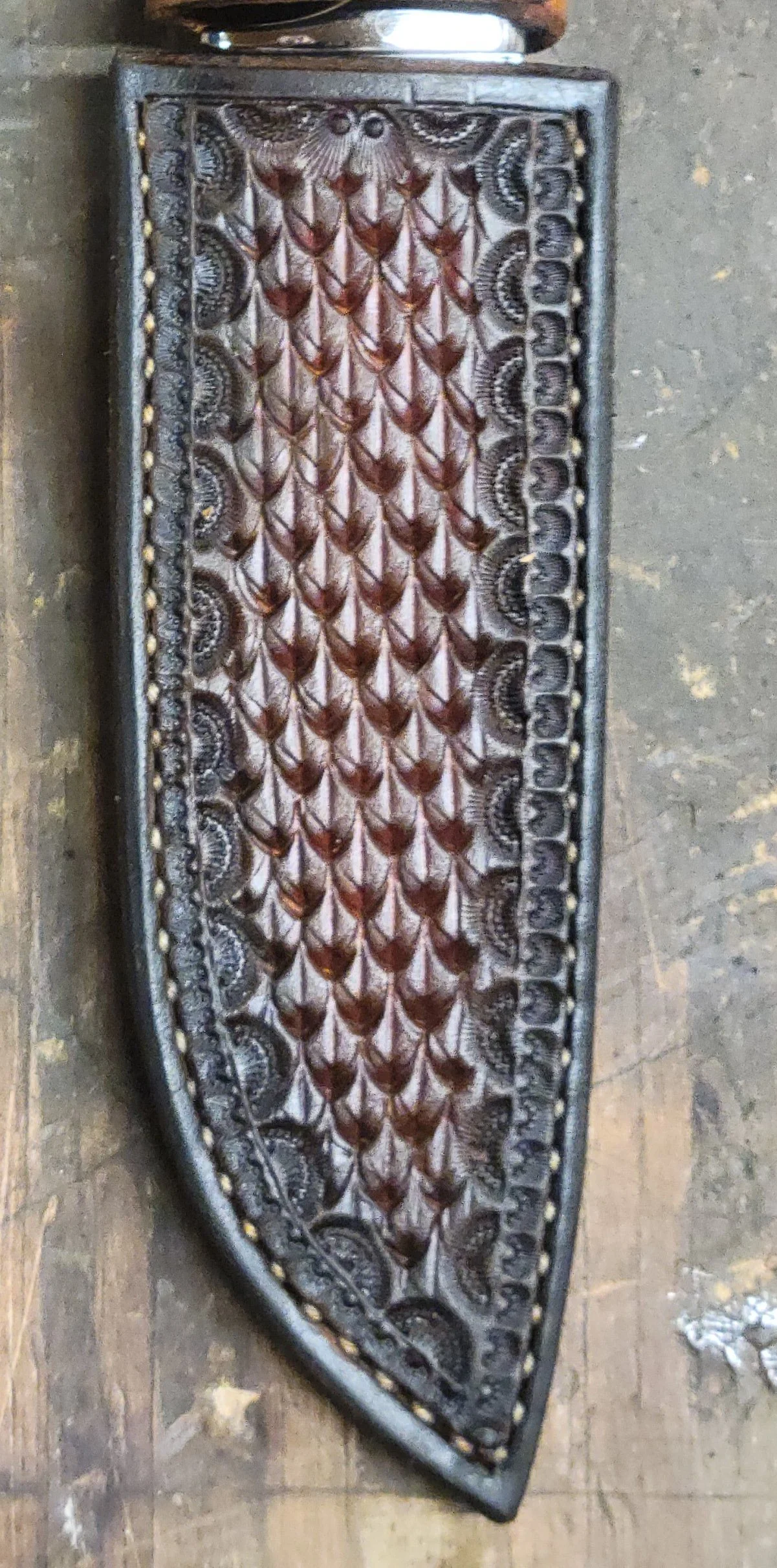 B.A. Dodson Desert Ironwood fixed-blade hunter leather sheath showing hand-tooled basketweave stamping, decorative border work, and hand stitching.