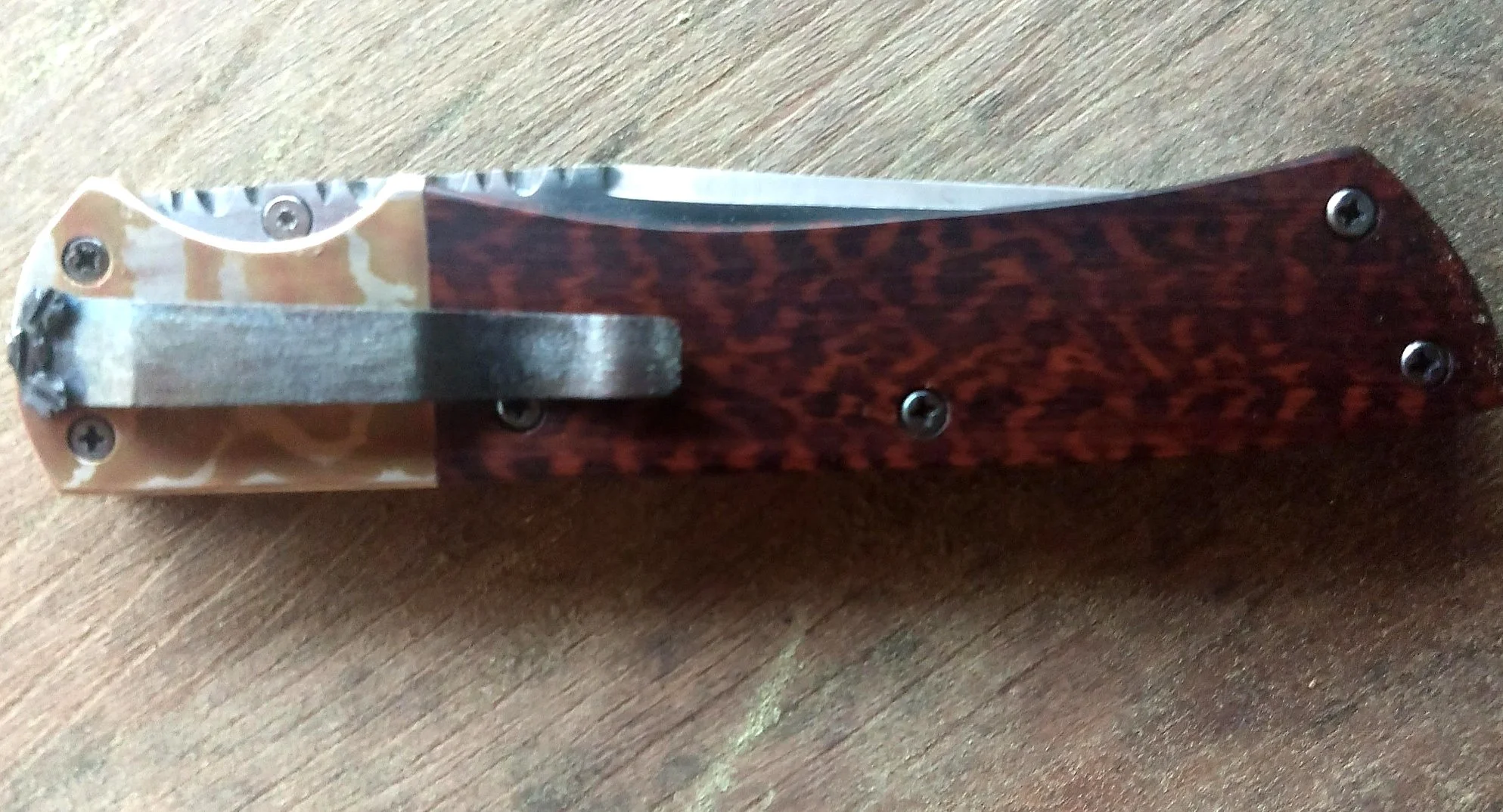 B.A. Dodson Snakewood and Mokume return-to-craft liner lock folder shown closed, highlighting the titanium pocket clip, figured Snakewood handle, Mokume bolster, and decorative file-work.