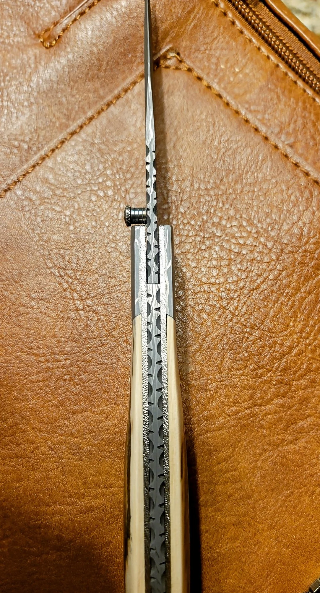 B.A. Dodson Mammoth Ivory and Damasteel folder spine detail showing the fileworked backspacer, liners, and blade construction.