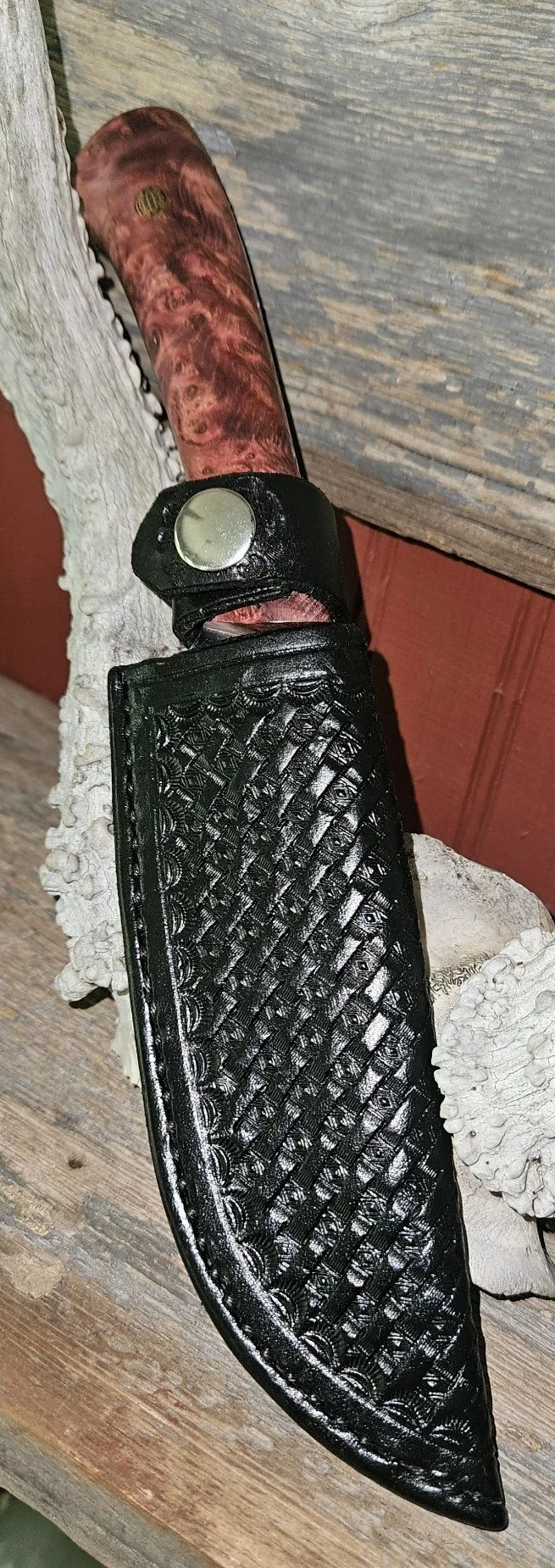 B.A. Dodson presentation wood fixed blade in a black basketweave leather sheath, showing the figured wood handle and hand-tooled leatherwork.