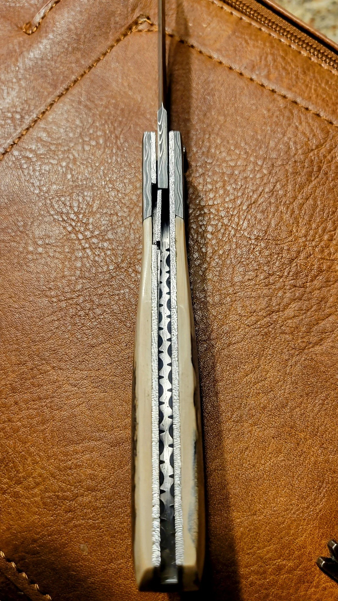 B.A. Dodson Mammoth Ivory and Damasteel Damascus folder interior showing the fileworked backbar, liners, and internal construction.
