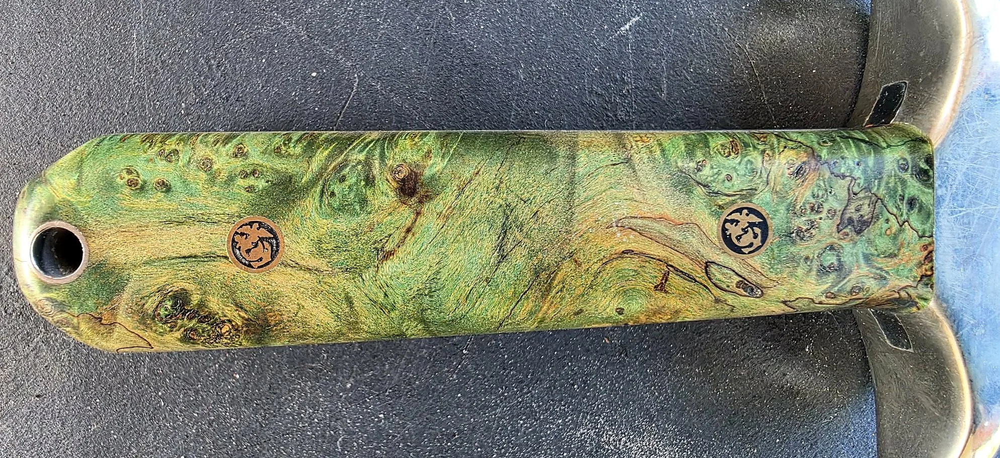 B.A. Dodson giraffe-bone dagger handle detail showing the figured handle material, U.S. Marine Corps emblem pins, guard, and lanyard hole.