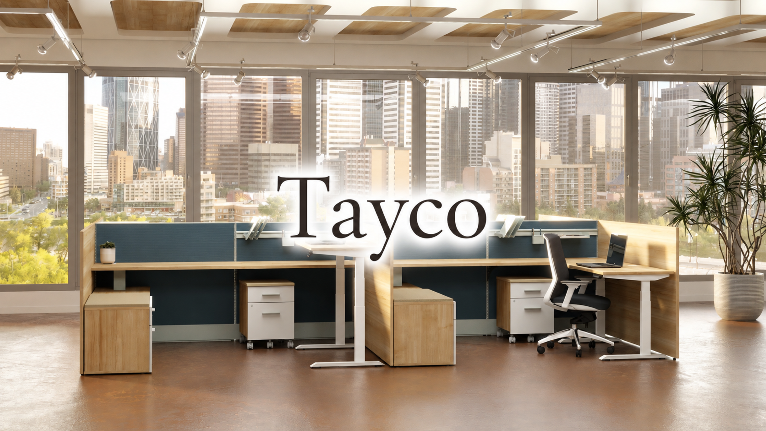 Modern office with large windows overlooking a city skyline, desks with computers, a potted plant, and a prominent sign that says 'Tayco' in the center.