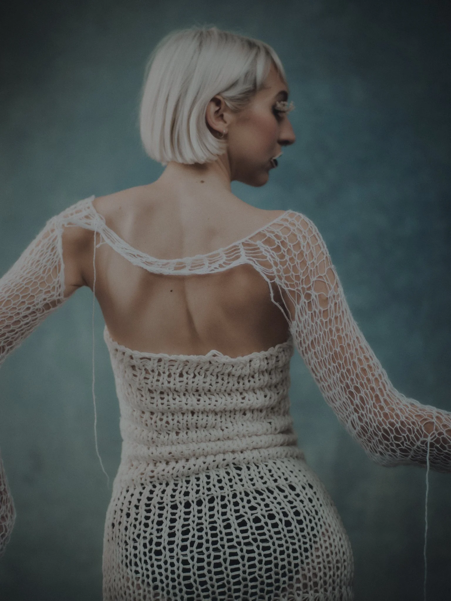 Editorial look showcasing handmade string lashes, sculpted face and handmade garments.