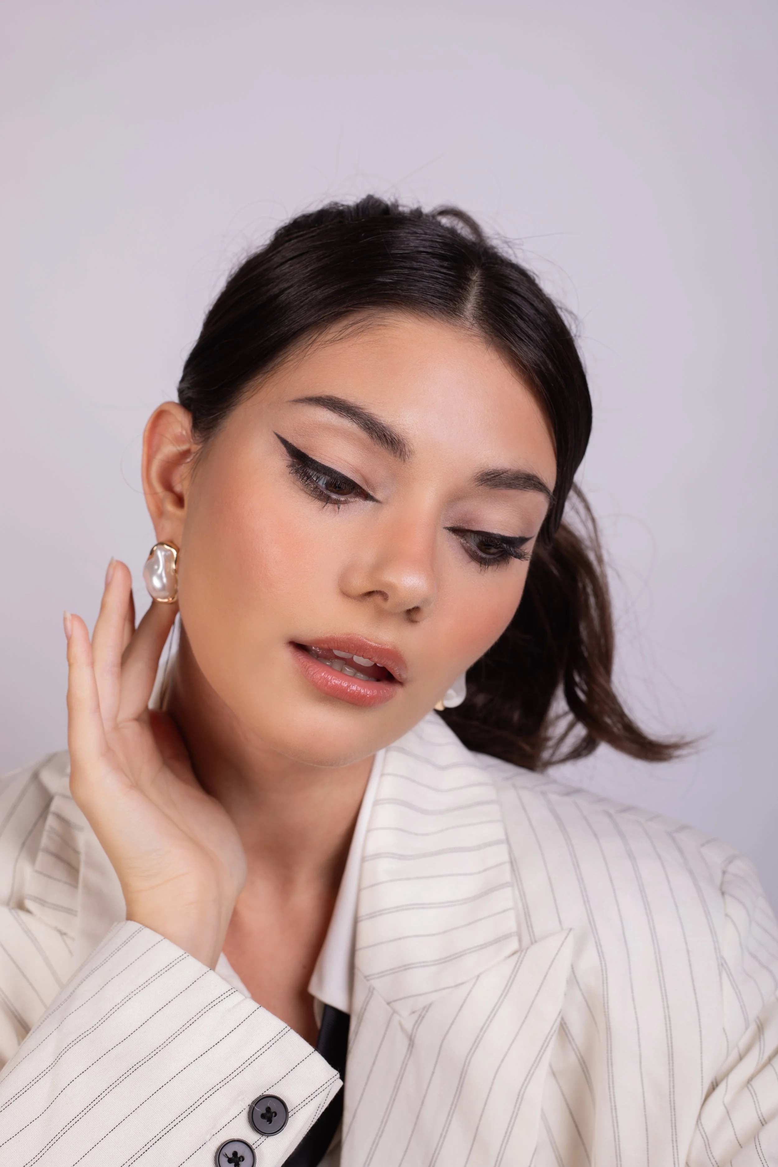 Pippa of London beauty Campaign. Dramatic eyeliner and sculpted skin with modern detailing. Applied with care and precision by Kinga, showcasing clean skin, sharp definition, and professional beauty application. Ideal for brand campaigns.
