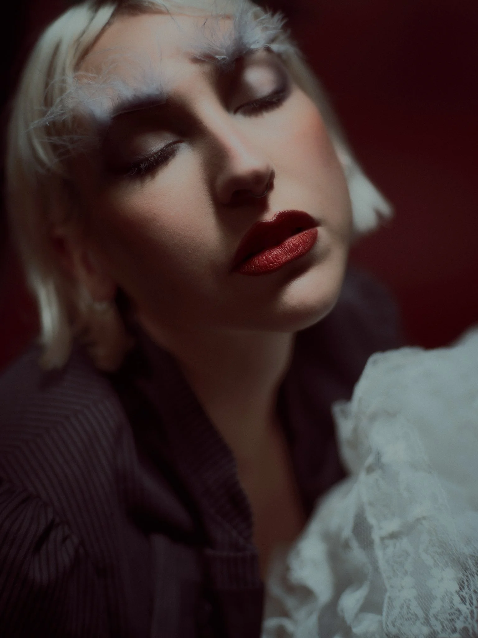 Artistic editorial makeup featuring soft glow, natural texture, and feather detailing. Kinga’s signature blend of expressive creativity and refined beauty.