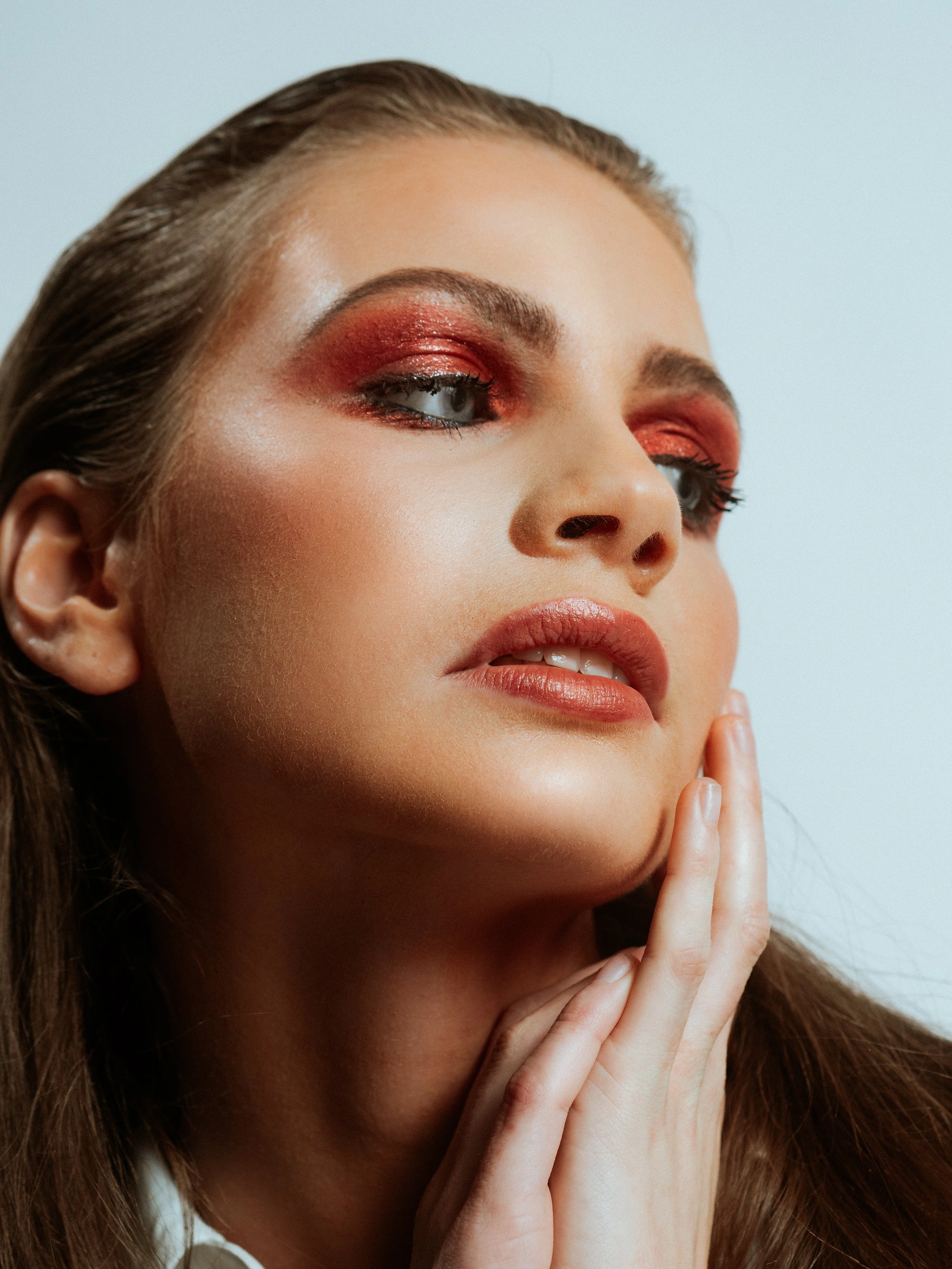 Modern use of colour in makeup. Red eyeshadow with soft focus skin work. Editorial beauty by Kinga for commercial and beauty imagery