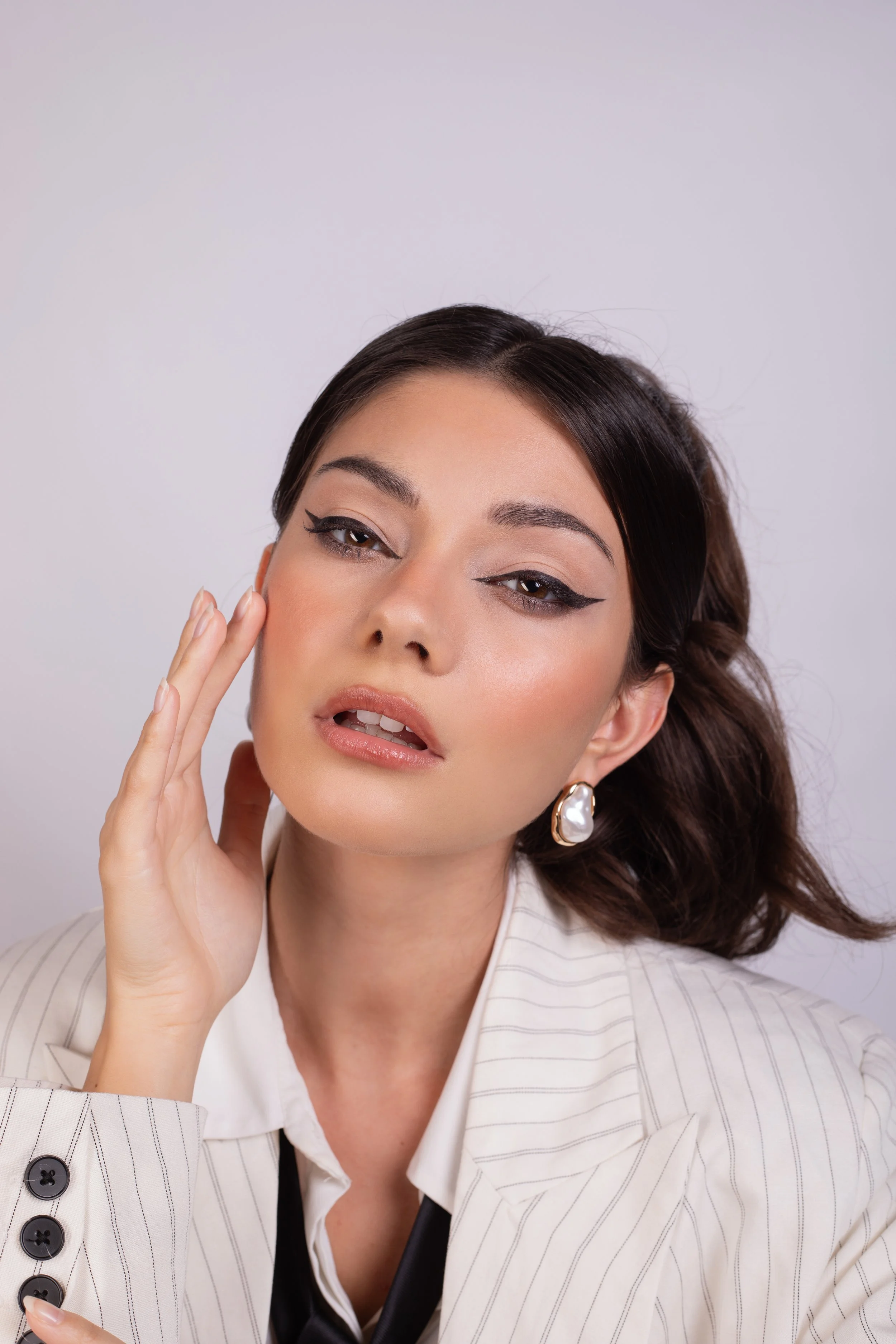 Pippa of London beauty Campaign. Dramatic eyeliner and sculpted skin with modern detailing. Applied with care and precision by Kinga, showcasing clean skin, sharp definition, and professional beauty application. Ideal for brand campaigns.