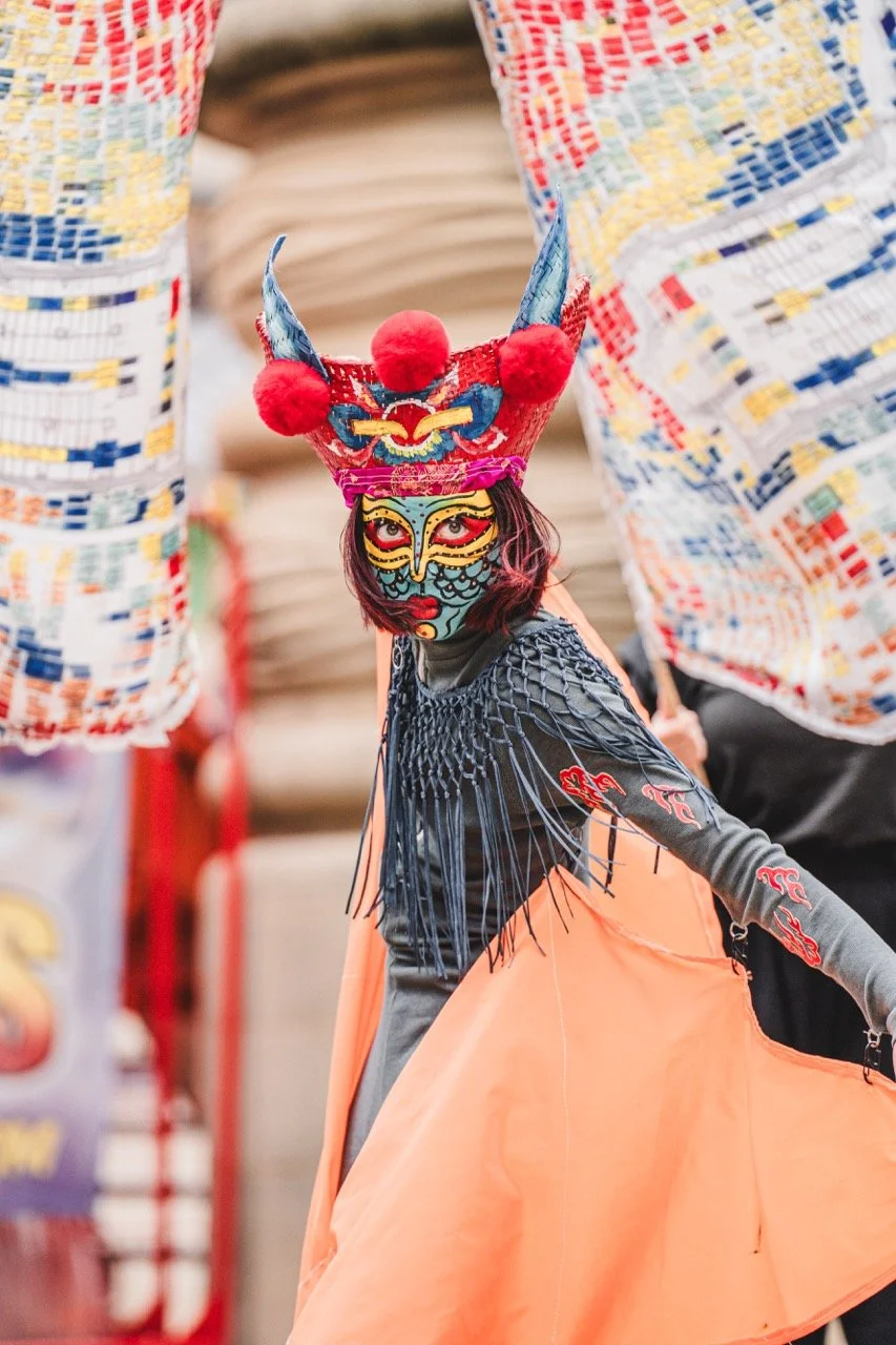 Ancestral Futures by Ellyn Lee. Vibrant face mask makeup designed and applied by Kinga featuring expressive colour, textured styling.  Bold character design, celebrating individuality and artistic expression.