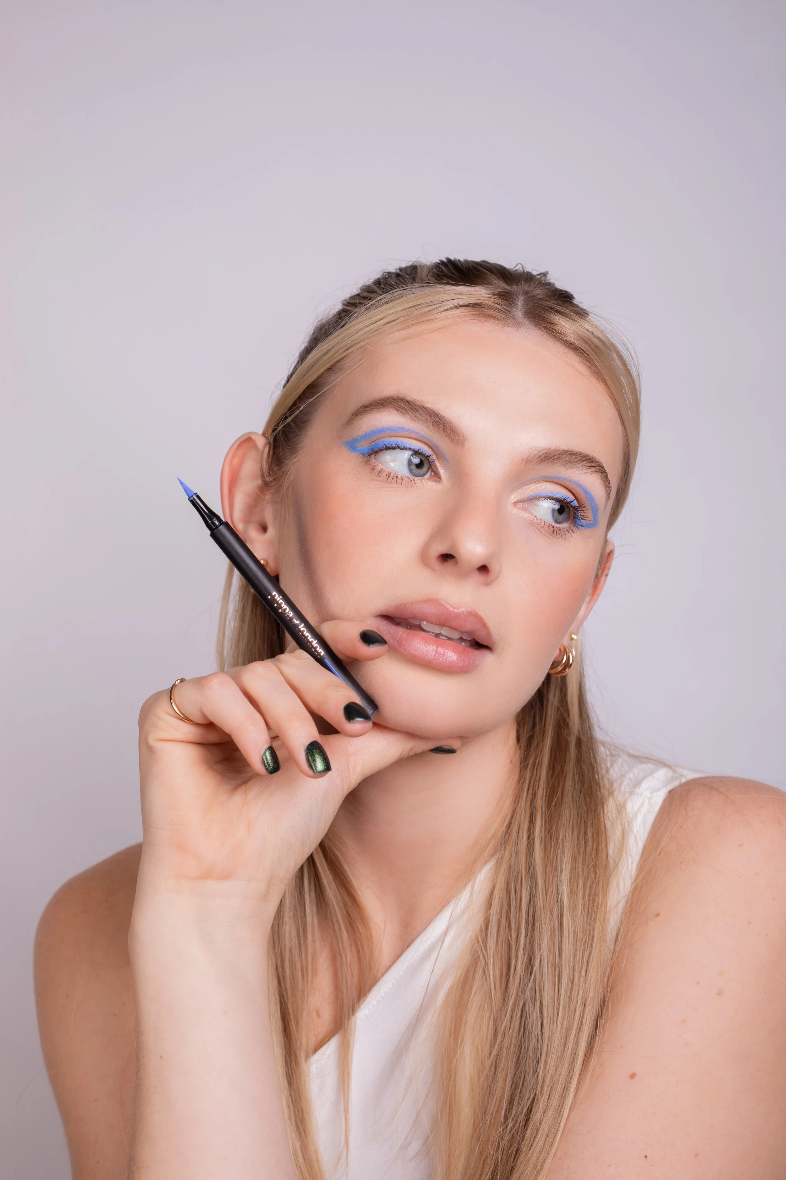 Pippa of London beauty Campaign. Beauty makeup by Kinga featuring bold blue shimmer, clean skin, and refined detailing. Perfect for beauty campaigns and modern commercial work.